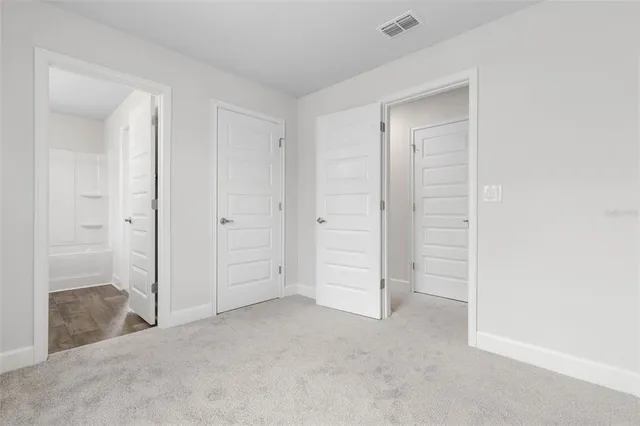 an empty room with closet area