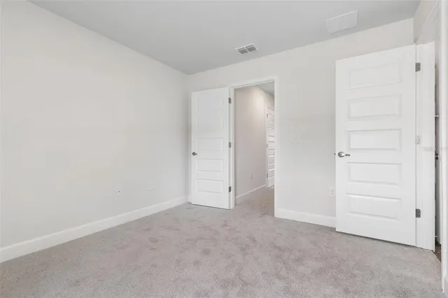 an empty room with closet area