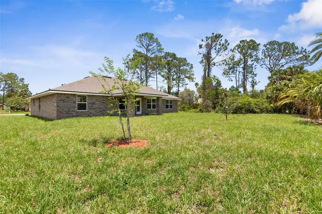 a aerial view of a house with a yard