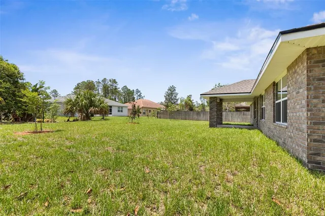 a yellow house with trees in front of it