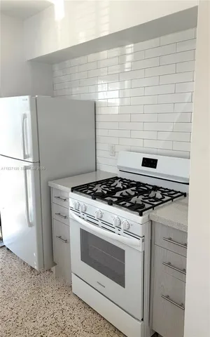 a stove top oven sitting inside of a kitchen