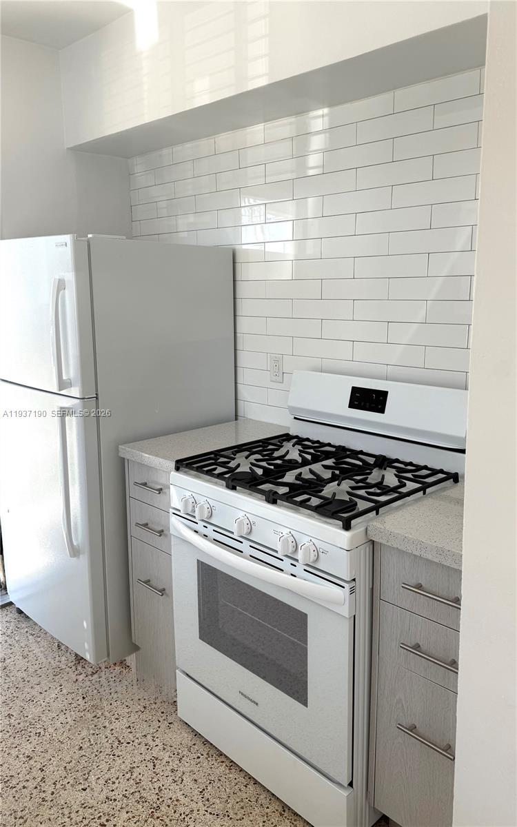 887 80th Street, Unit 1 Miami Beach, FL 33141 - Photo 11 of 19 a stove top oven sitting inside of a kitchen