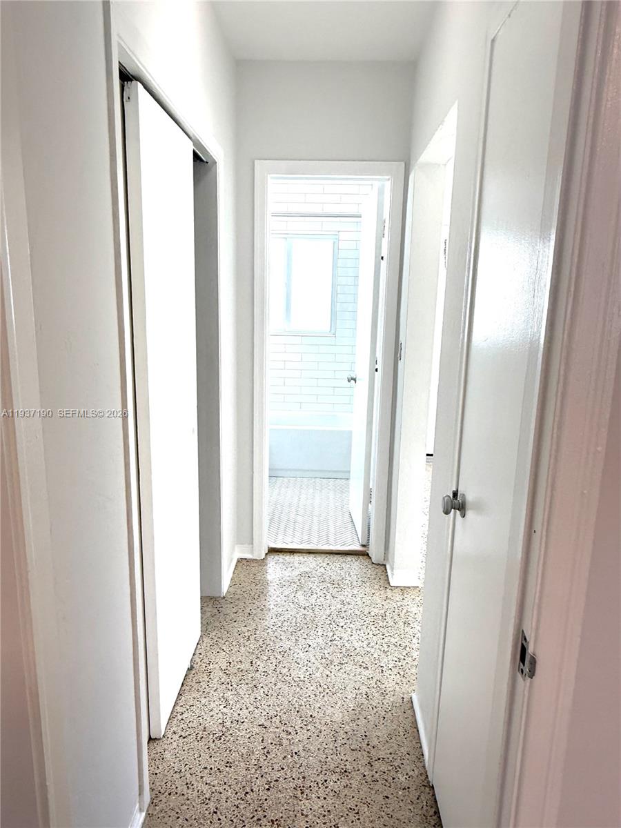 887 80th Street, Unit 1 Miami Beach, FL 33141 - Photo 13 of 19 a view of a bathroom with wooden floor and a carpet