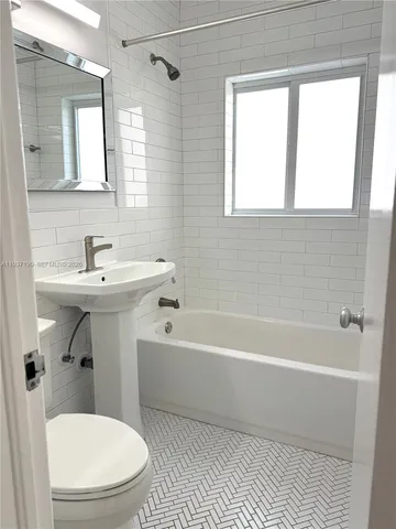 a bathroom with a sink a toilet and a bathtub