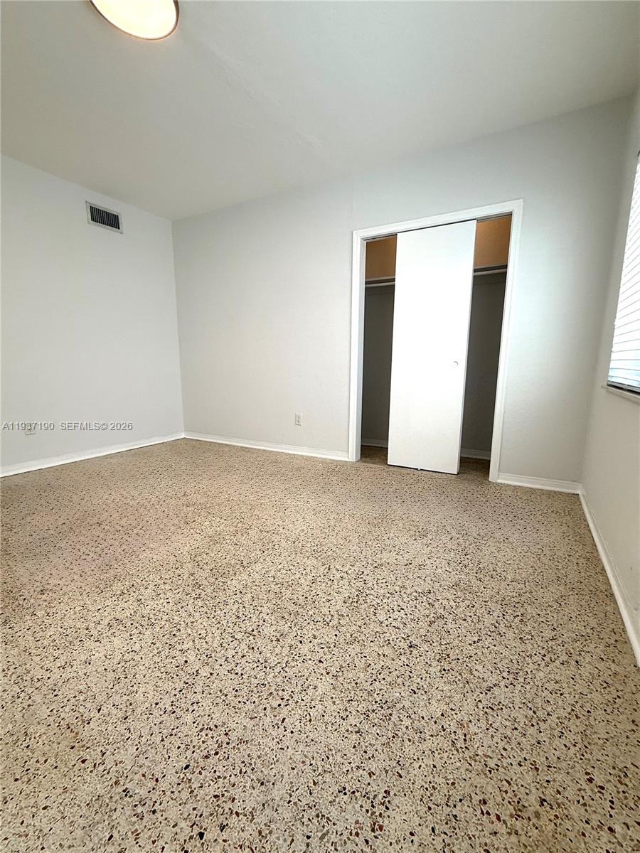 887 80th Street, Unit 1 Miami Beach, FL 33141 - Photo 15 of 19 a view of an empty room and window