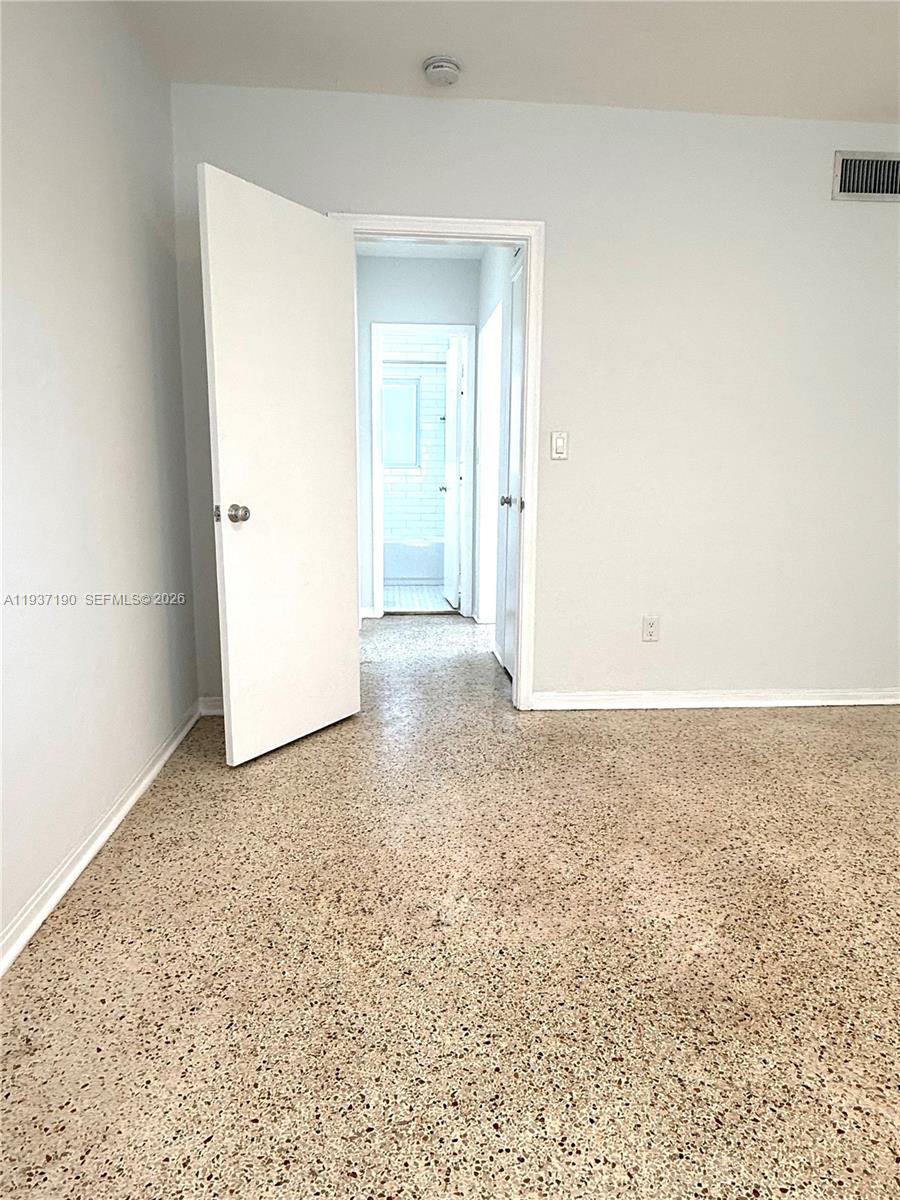 887 80th Street, Unit 1 Miami Beach, FL 33141 - Photo 16 of 19 an empty room with an entryway