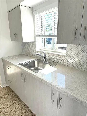 a kitchen with a sink and a window