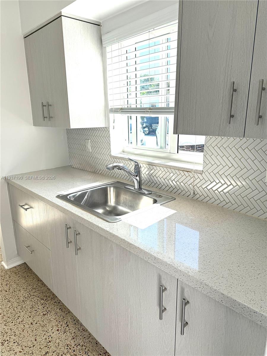 887 80th Street, Unit 1 Miami Beach, FL 33141 - Photo 10 of 19 a kitchen with a sink and a window