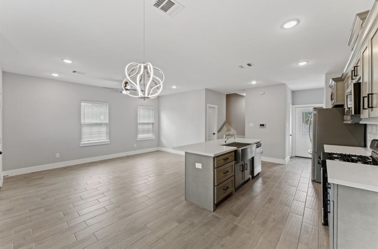 5140 Mallow Street Houston, TX 77033 - Photo 12 of 23 a kitchen with stainless steel appliances granite countertop a stove a sink and a refrigerator