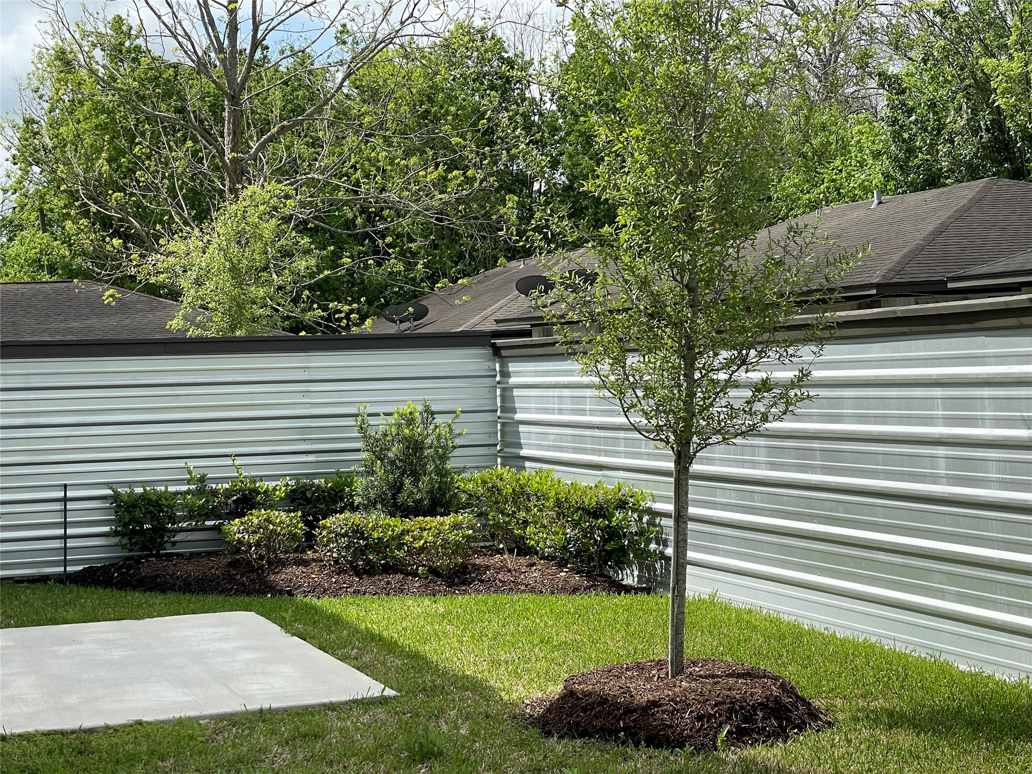 5140 Mallow Street Houston, TX 77033 - Photo 22 of 23 a view of a backyard with plants and a garden