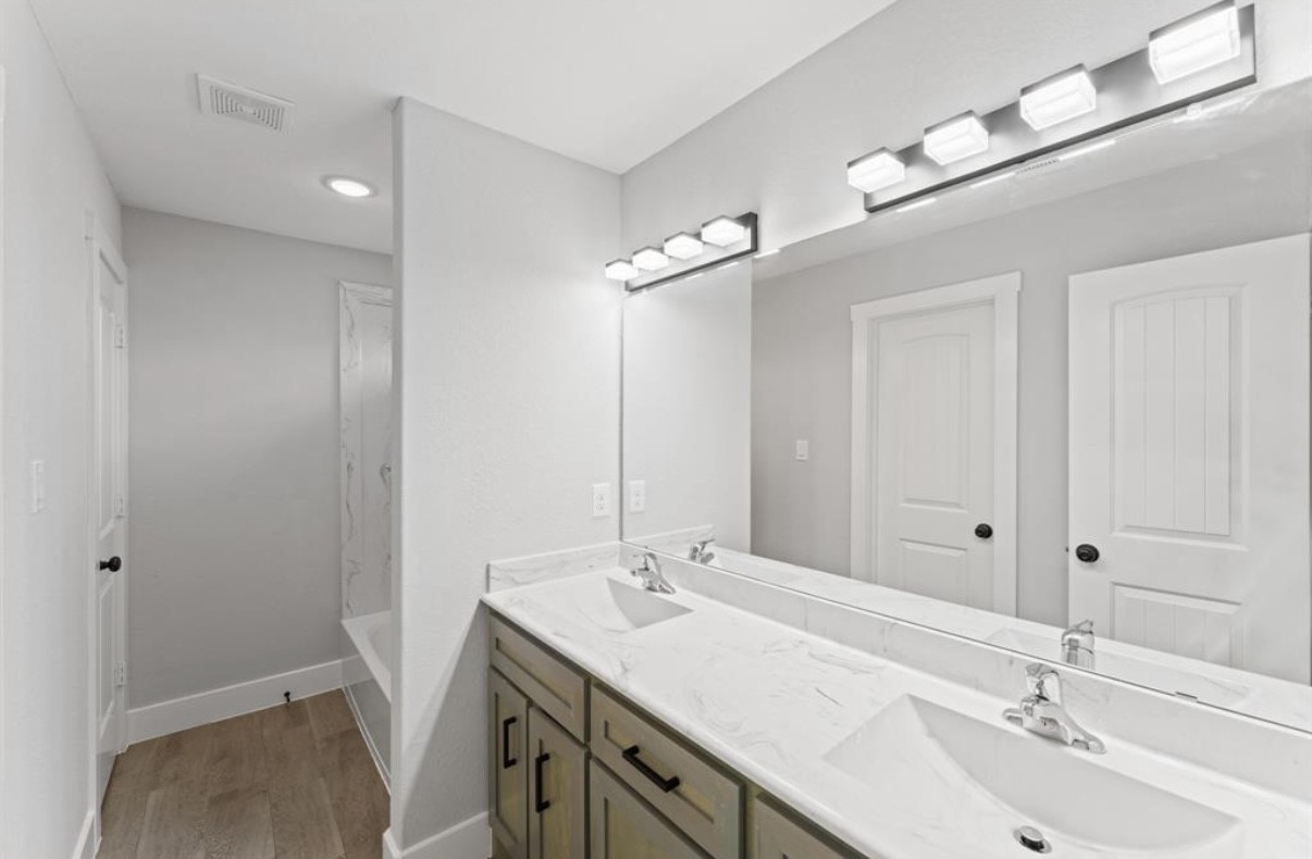5140 Mallow Street Houston, TX 77033 - Photo 8 of 23 a bathroom with a sink double vanity and a mirror