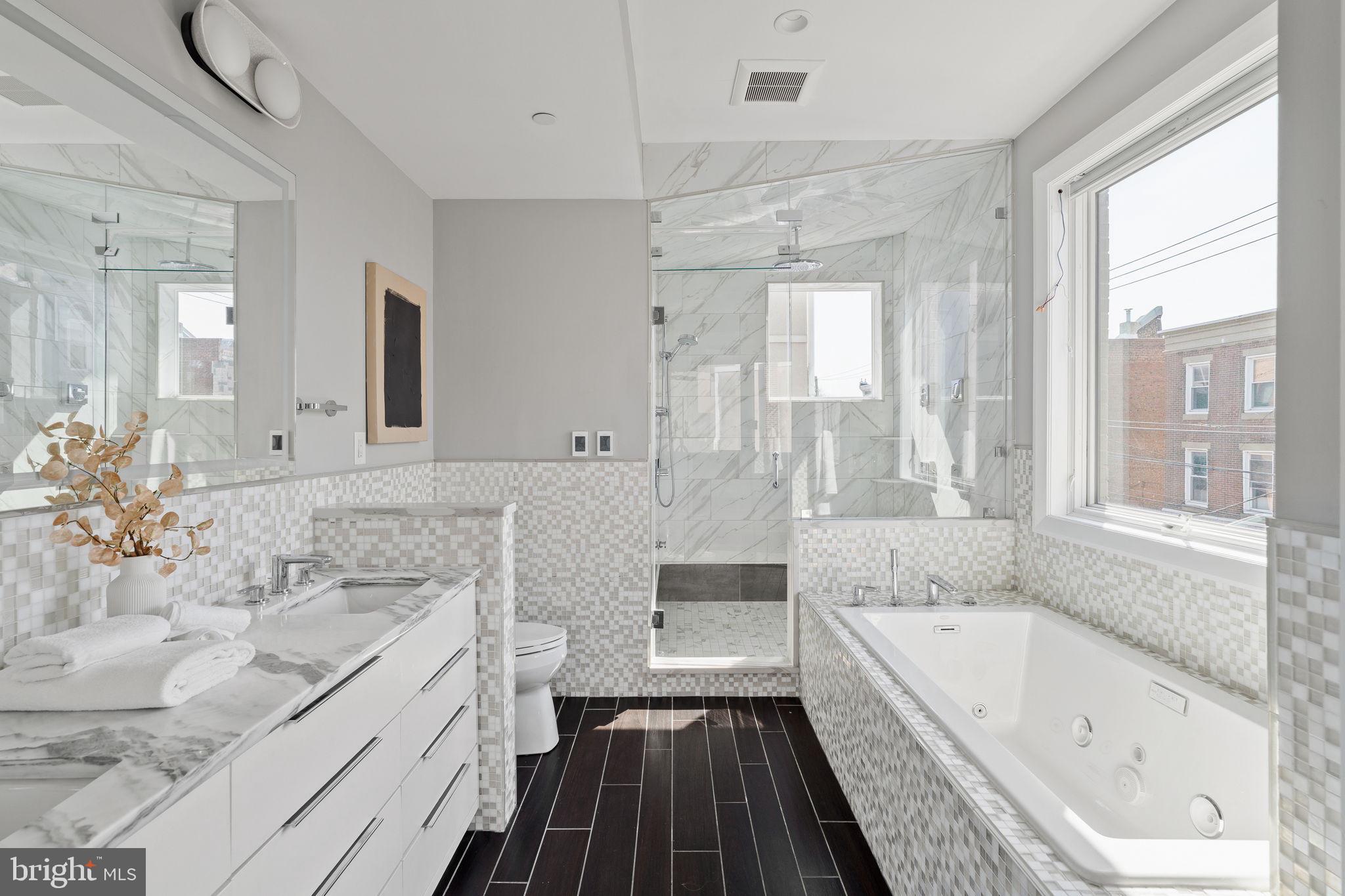519 Bainbridge Street, Unit A Philadelphia, PA 19147 - Photo 18 of 44 a bathroom with a granite countertop tub sink and mirror