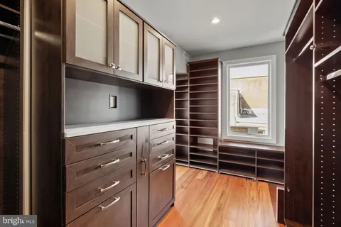 a kitchen with granite countertop white cabinets and window