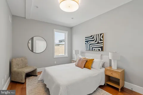 a bedroom with a bed and chair