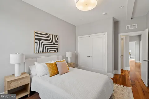 a bedroom with a bed and painting on the wall