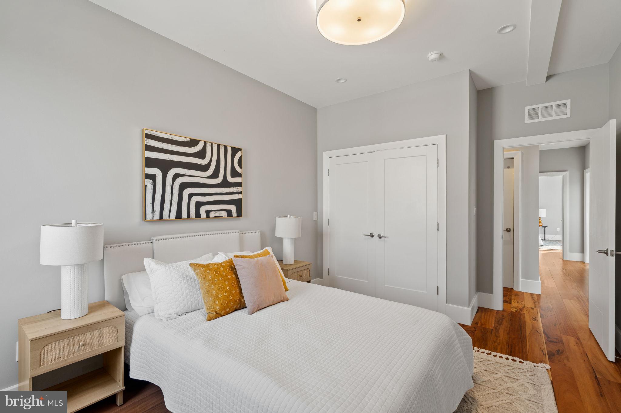 519 Bainbridge Street, Unit A Philadelphia, PA 19147 - Photo 25 of 44 a bedroom with a bed and painting on the wall