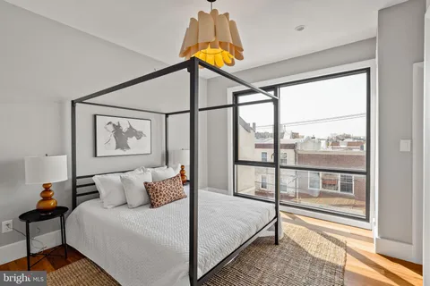 a bedroom with furniture and a window