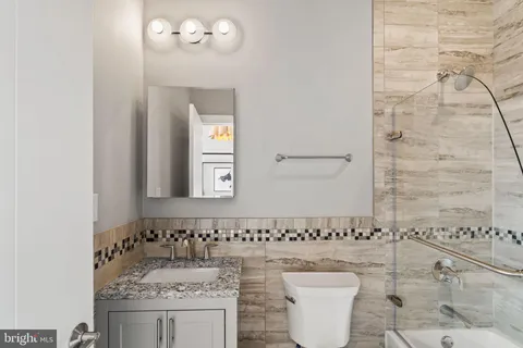 a bathroom with a sink a toilet and mirror