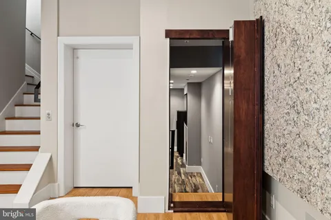 a view of an empty room with a fireplace and a window