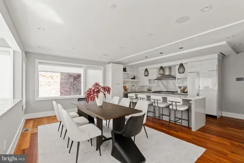 a dining room with furniture and wooden floor