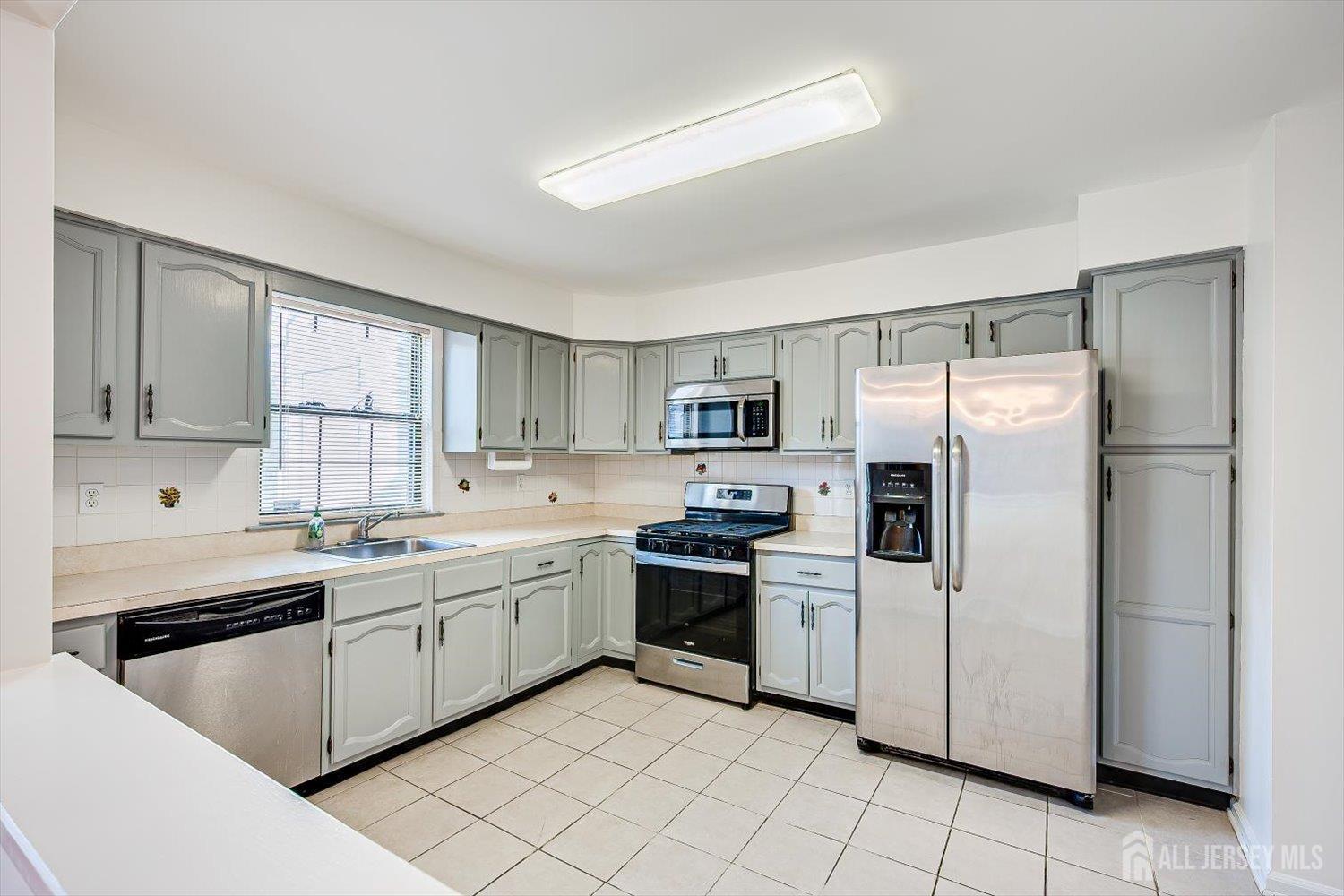 404 Maplecrest Road Edison, NJ 08820 - Photo 11 of 25 a kitchen with appliances cabinets and a sink