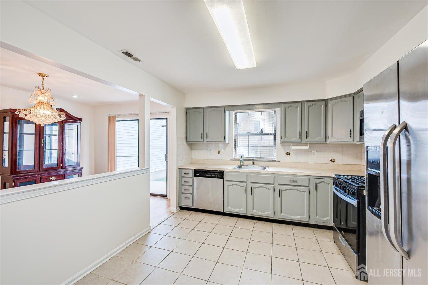 404 Maplecrest Road Edison, NJ 08820 - Photo 13 of 25 a large white kitchen with cabinets a sink and appliances
