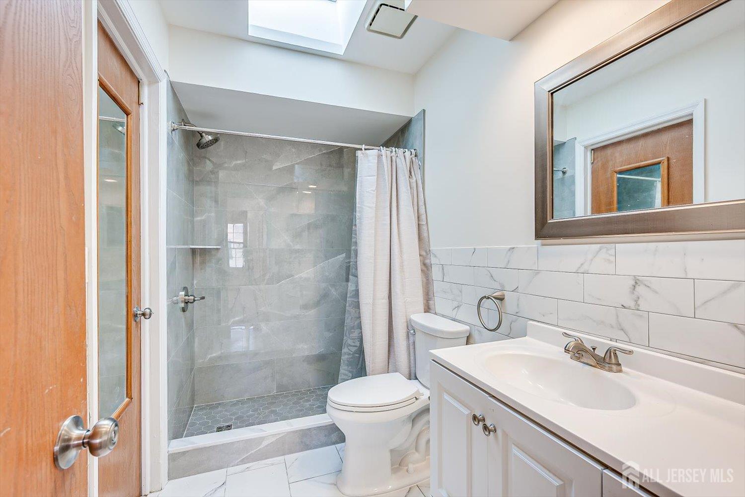 404 Maplecrest Road Edison, NJ 08820 - Photo 20 of 25 a bathroom with a sink toilet and shower
