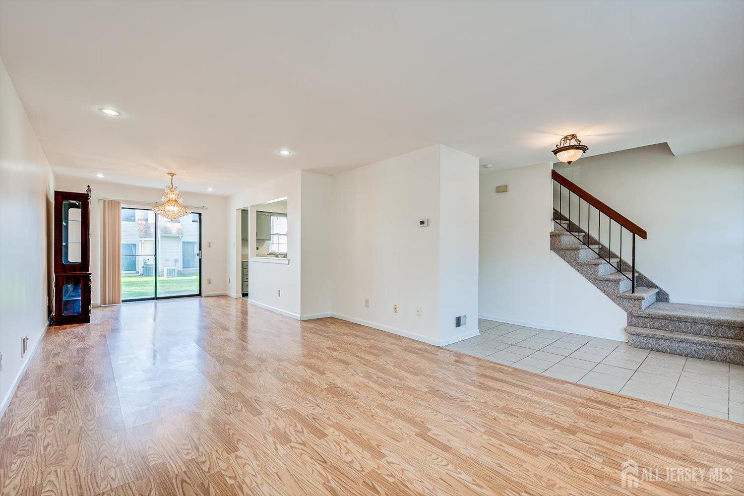 404 Maplecrest Road Edison, NJ 08820 - Photo 6 of 25 a view of an empty room with wooden floor and a window