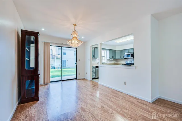 a view of a kitchen and window with wooden floor