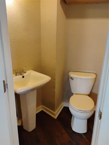 a white toilet sitting next to a bathroom sink