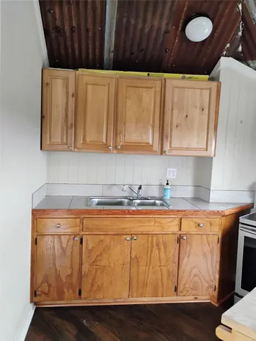 a kitchen with wooden cabinets