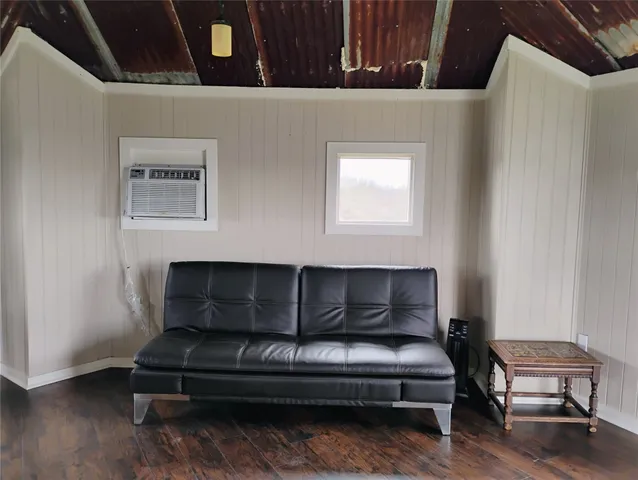 a bedroom with furniture and a wooden floor