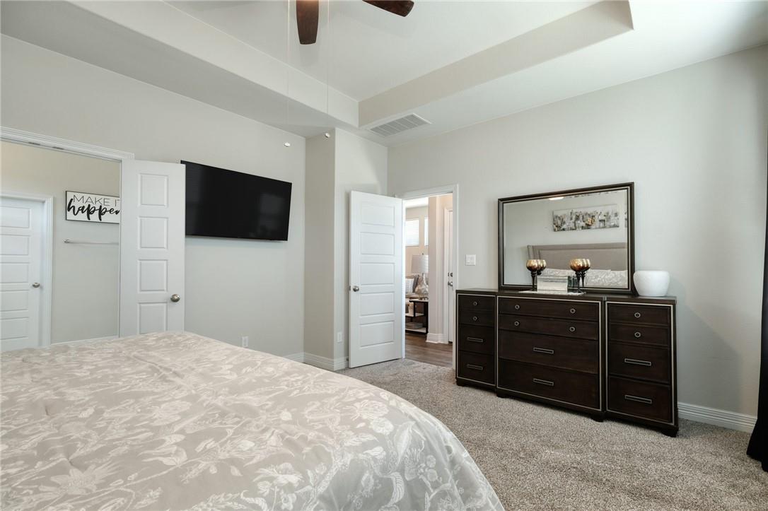 229 Bonnet Boulevard Georgetown, TX 78628 - Photo 9 of 20 Bedroom with a raised ceiling, light colored carpet, and ceiling fan