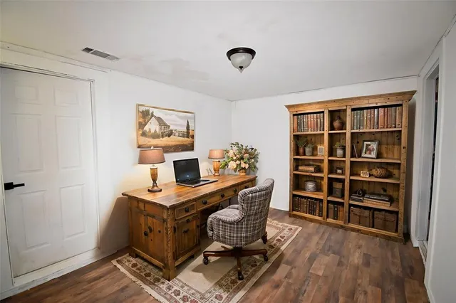 a view of a workspace with furniture and wooden floor