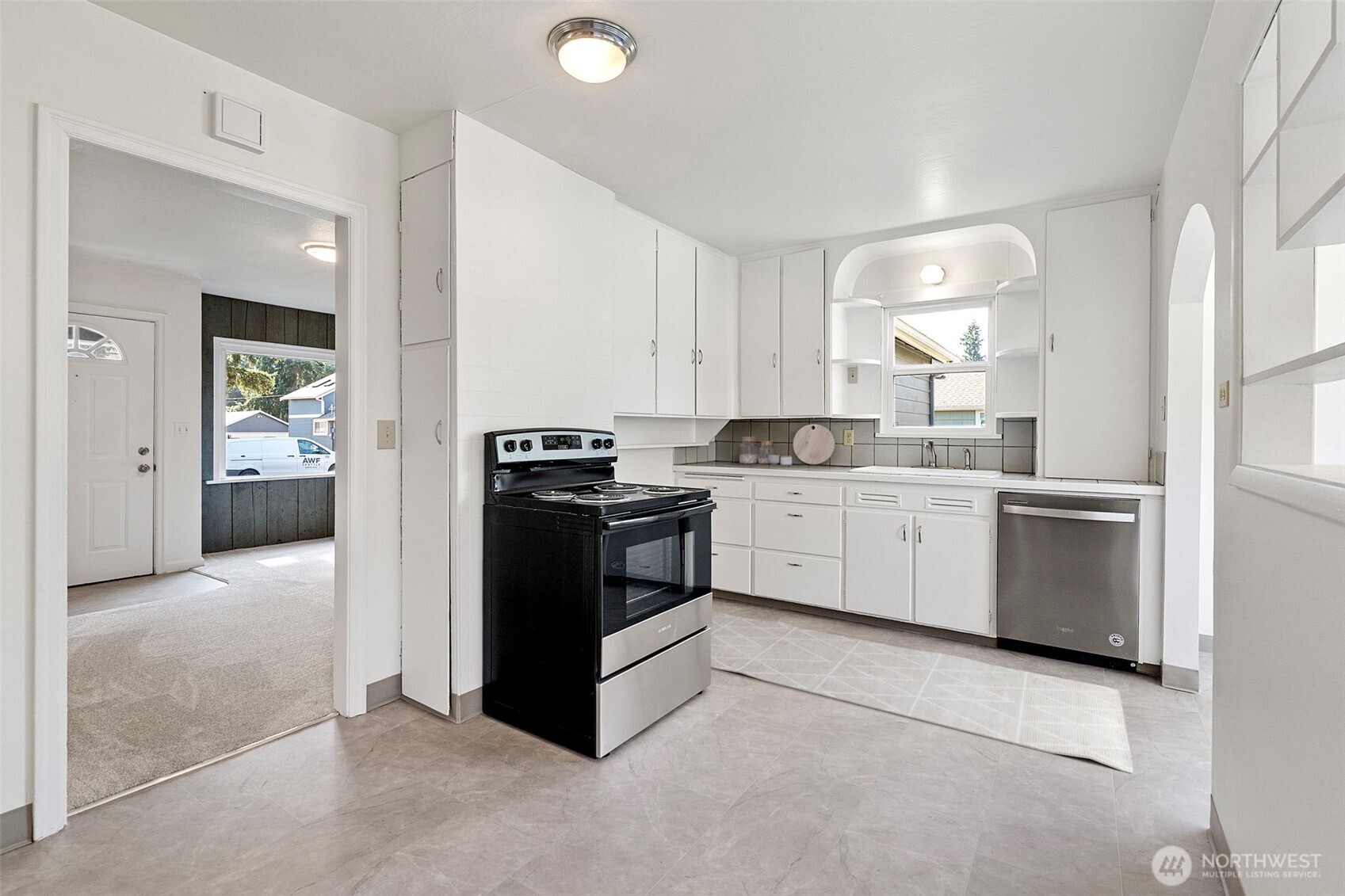 717 Ramsdell Street Fircrest, WA 98466 - Photo 5 of 29 a kitchen with a stove sink and cabinets
