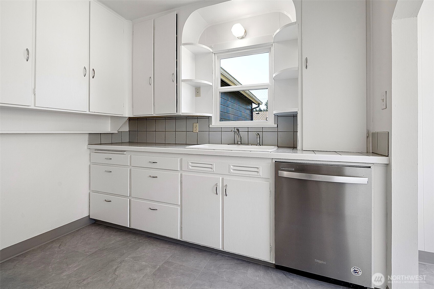 717 Ramsdell Street Fircrest, WA 98466 - Photo 6 of 29 a kitchen with white cabinets and sink