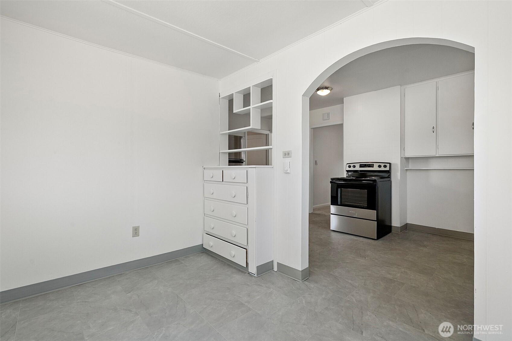 717 Ramsdell Street Fircrest, WA 98466 - Photo 8 of 29 a kitchen with white cabinets and stainless steel appliances
