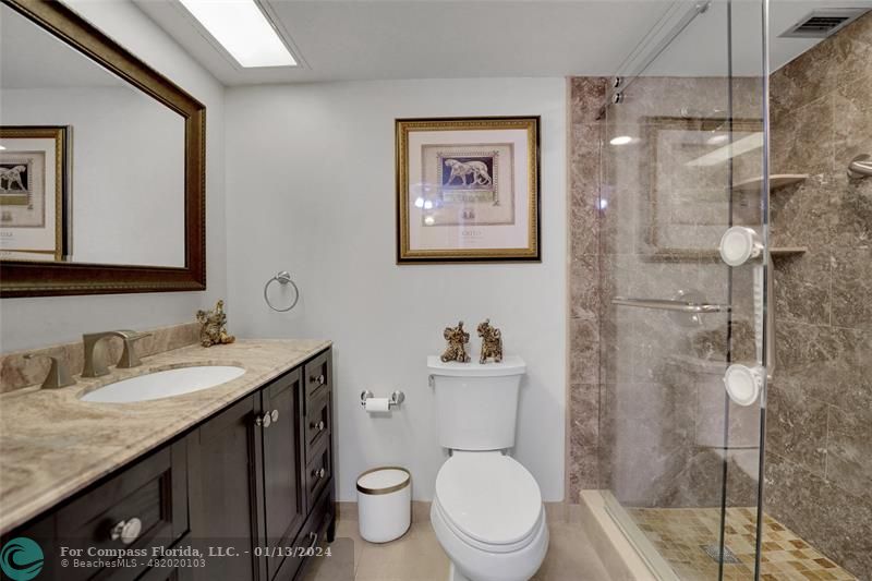 Palm Aire Pompano Beach, FL 33069 - Photo 8 of 12 a bathroom with a granite countertop toilet sink and shower