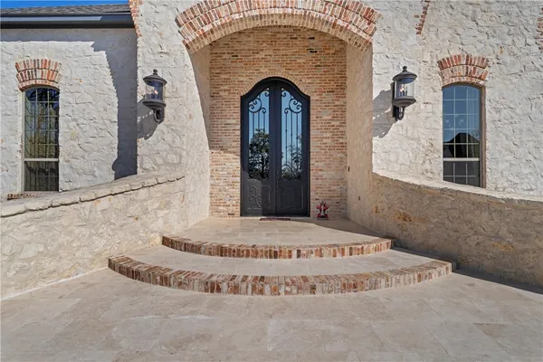 a view of a room with wooden floor and windows