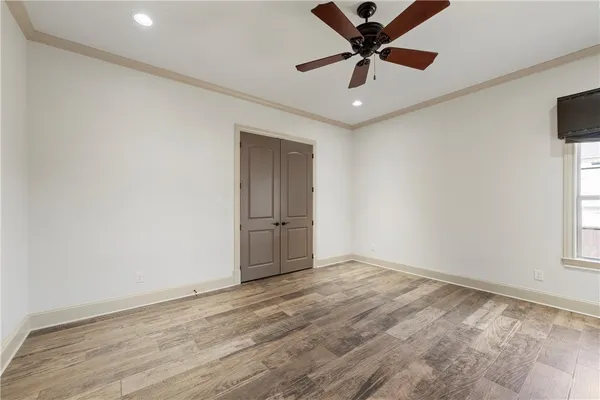 a view of walk in closet with empty racks