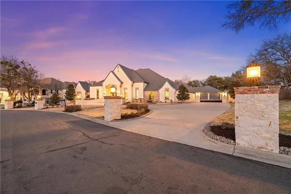 a view of a house with swimming pool and sitting area