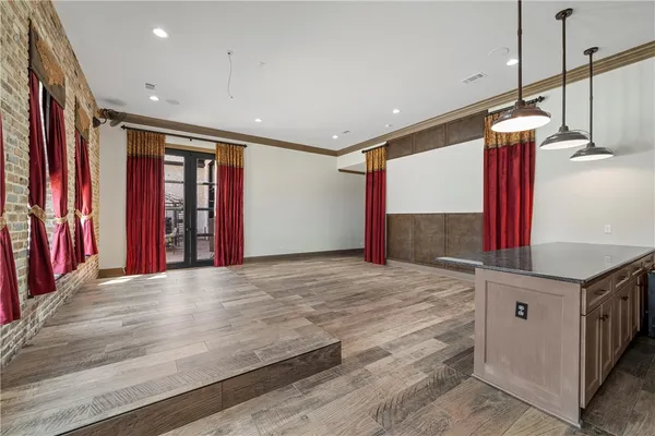 a bathroom with a granite countertop sink a mirror and shower