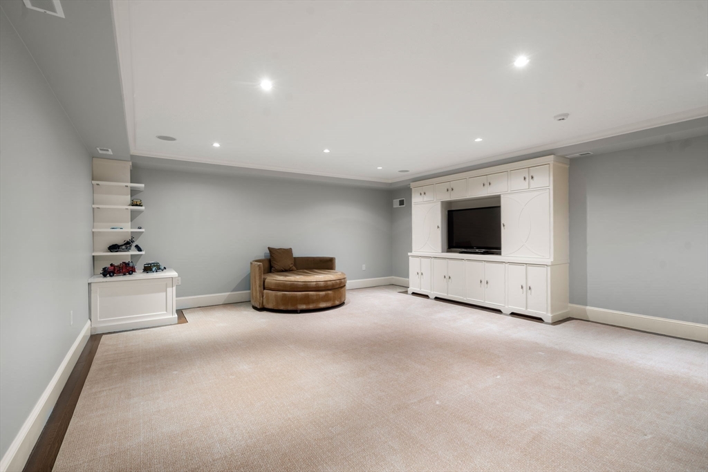 14 Greylock Road Wellesley, MA 02481 - Photo 21 of 24 a living room with furniture and a flat screen tv