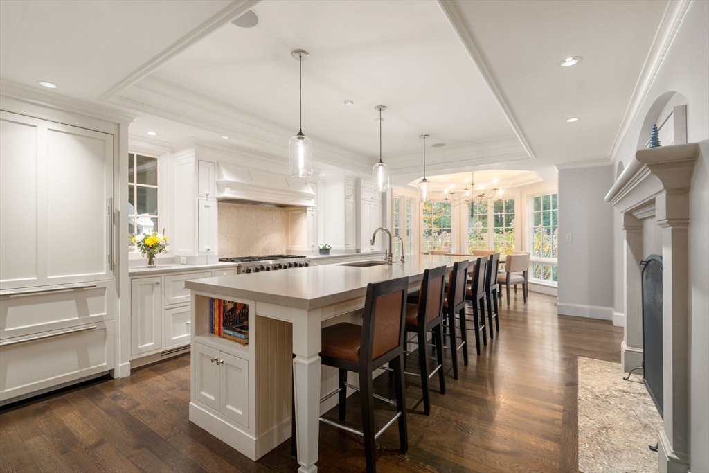 14 Greylock Road Wellesley, MA 02481 - Photo 8 of 24 a kitchen with stainless steel appliances granite countertop a stove a refrigerator a oven a sink with a dining table and chairs