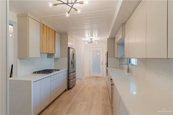 a kitchen with stainless steel appliances a refrigerator sink and cabinets