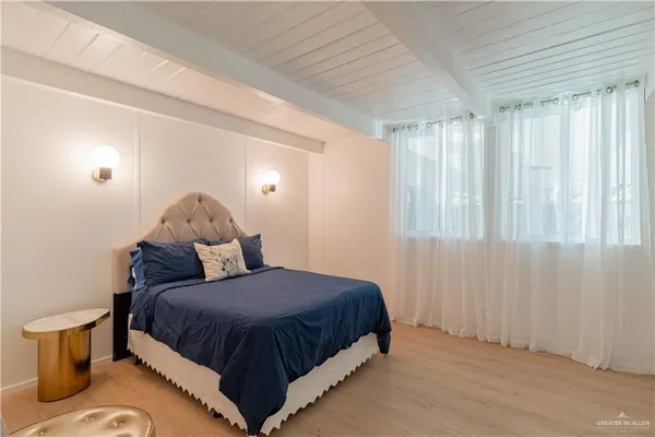 a bedroom with a bed and window