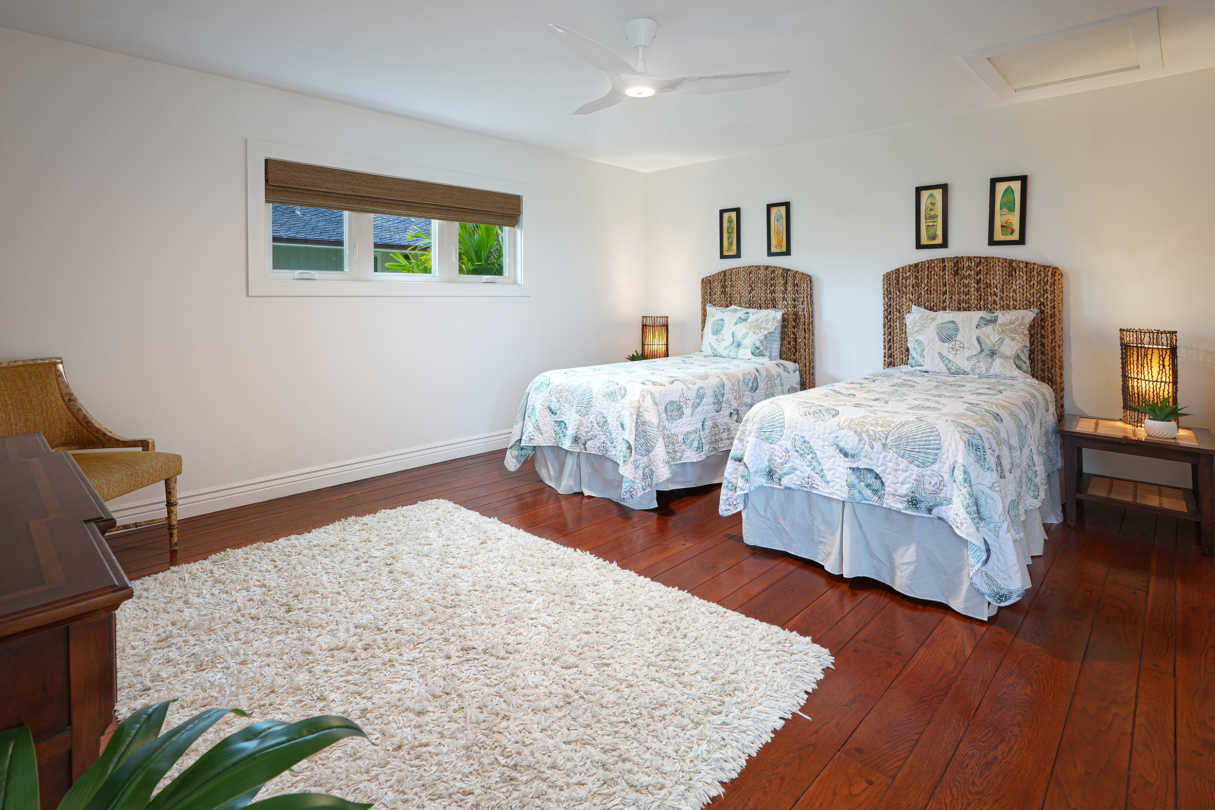5348 Honoiki Road Princeville, HI 96722 - Photo 16 of 25 a bedroom with two beds and painting on the wall