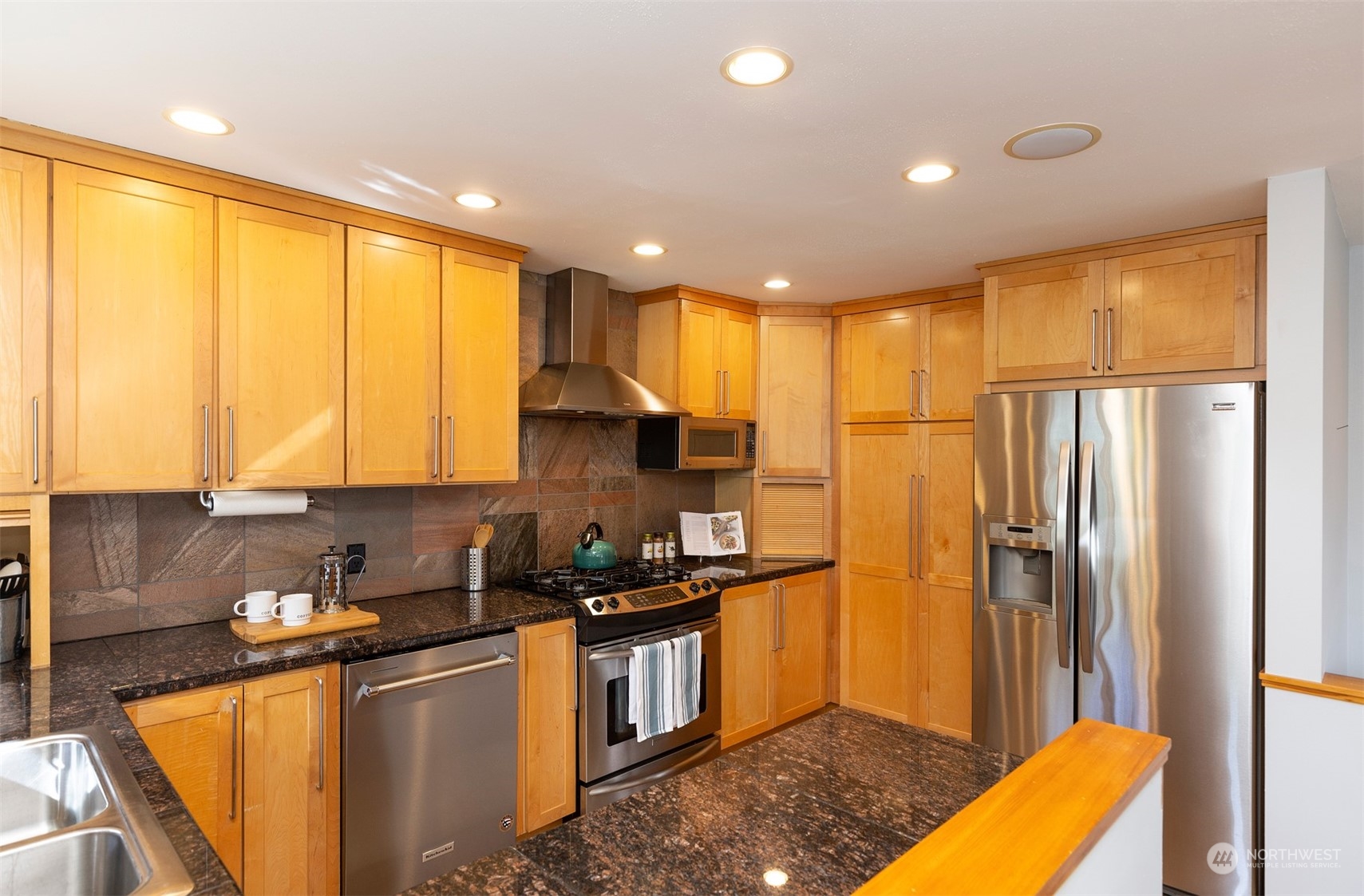 1505 35th Avenue South Seattle, WA 98144 - Photo 11 of 39 a kitchen with stainless steel appliances granite countertop a refrigerator a sink and a stove top oven