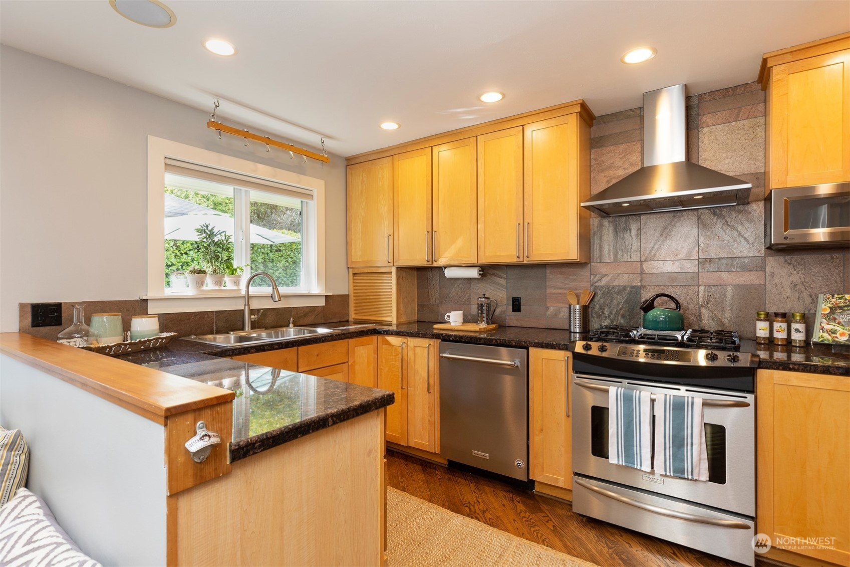 1505 35th Avenue South Seattle, WA 98144 - Photo 14 of 39 a kitchen with stainless steel appliances granite countertop sink stove top oven and cabinets