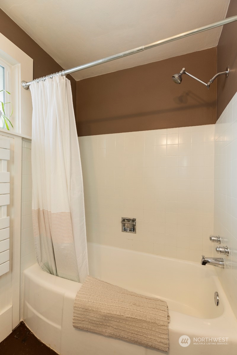 1505 35th Avenue South Seattle, WA 98144 - Photo 21 of 39 a bathroom with a bathtub and a shower